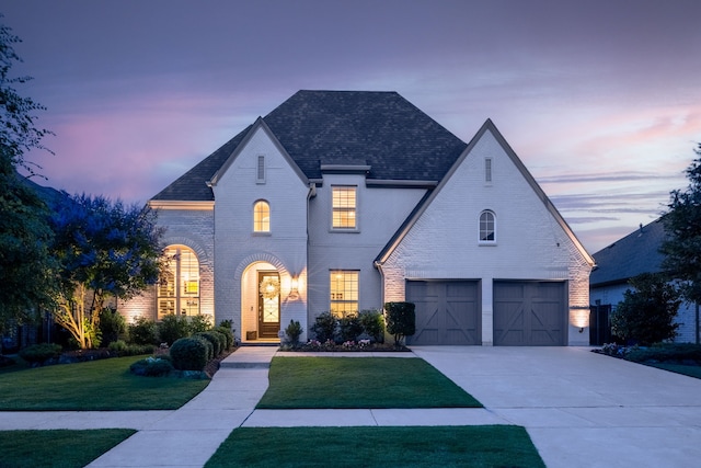 16471 Prairie Oak Rd, Frisco, TX 75033 - french country inspired facade with a front yard, brick siding, and driveway