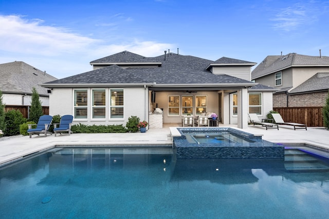 16471 Prairie Oak Rd, Frisco, TX 75033 - back of house featuring a patio area, roof with shingles, a pool with connected hot tub, and a ceiling fan