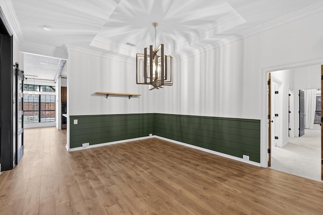 4000 Tumbril Ln, Plano, TX 75023 - unfurnished room with ornamental molding, light wood-type flooring, a wainscoted wall, and a chandelier