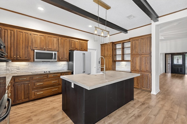 4000 Tumbril Ln, Plano, TX 75023 - kitchen with stainless steel microwave, freestanding refrigerator, beamed ceiling, light countertops, and brown cabinetry