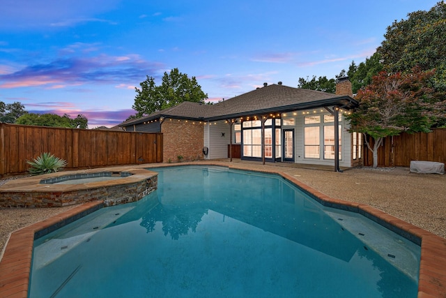 4000 Tumbril Ln, Plano, TX 75023 - pool at dusk featuring a pool with connected hot tub
