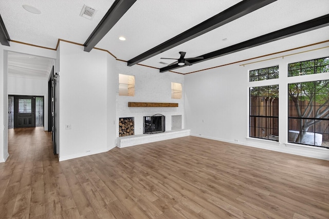 4000 Tumbril Ln, Plano, TX 75023 - unfurnished living room featuring ceiling fan, beam ceiling, wood finished floors, a textured ceiling, and crown molding