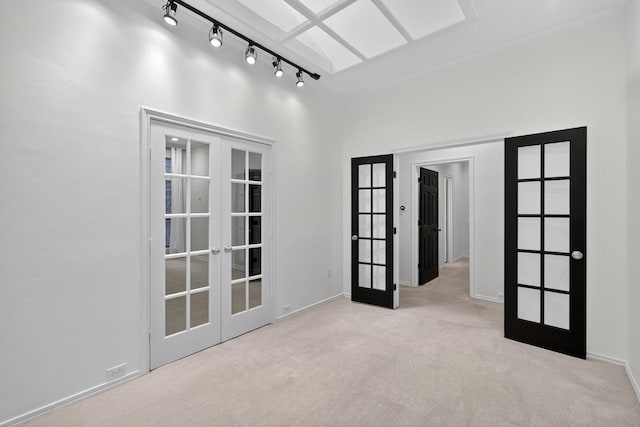 4000 Tumbril Ln, Plano, TX 75023 - unfurnished room featuring french doors, carpet flooring, rail lighting, and baseboards