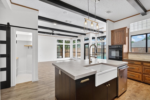4000 Tumbril Ln, Plano, TX 75023 - kitchen featuring black oven, stainless steel dishwasher, a sink, beam ceiling, and light wood-style floors