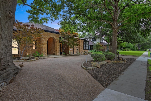 4000 Tumbril Ln, Plano, TX 75023 - view of front of house with brick siding and curved driveway
