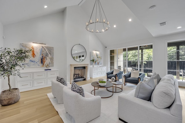 7141 Lyre Ln, Dallas, TX 75214 - living room featuring light wood finished floors, high vaulted ceiling, a fireplace, a chandelier, and recessed lighting
