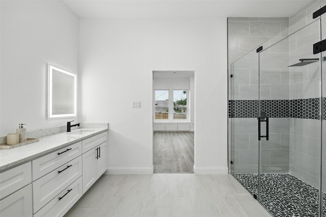 3220 N Houston, Fort Worth, TX 76106 - bathroom with baseboards, vanity, a stall shower, and marble finish flooring