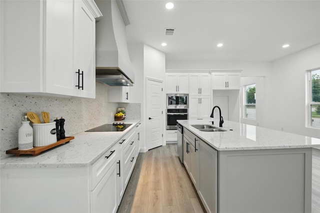 3220 N Houston, Fort Worth, TX 76106 - kitchen featuring a sink, stainless steel appliances, custom exhaust hood, light wood-style flooring, and white cabinets