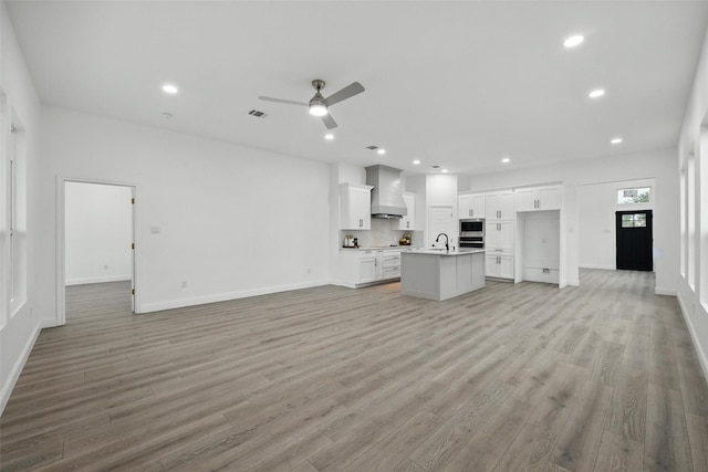3220 N Houston, Fort Worth, TX 76106 - unfurnished living room featuring a sink, light wood-style floors, ceiling fan, baseboards, and recessed lighting