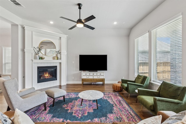 719 Forefront Ave, Celina, TX 75009 - living area featuring wood finished floors, ceiling fan, a tile fireplace, lofted ceiling, and recessed lighting