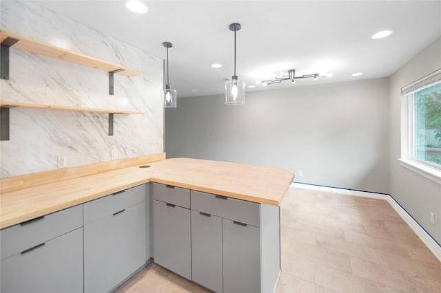 221 S 7th St, Jacksboro, TX 76458 - kitchen with butcher block countertops, a peninsula, open shelves, gray cabinetry, and recessed lighting