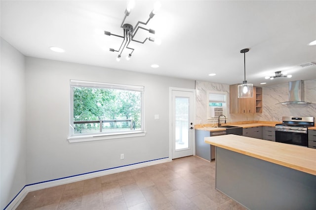 221 S 7th St, Jacksboro, TX 76458 - kitchen featuring stainless steel range oven, wall chimney exhaust hood, wood counters, open shelves, and a sink