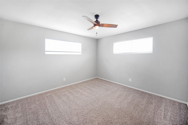 221 S 7th St, Jacksboro, TX 76458 - spare room featuring healthy amount of natural light, ceiling fan, carpet flooring, and baseboards
