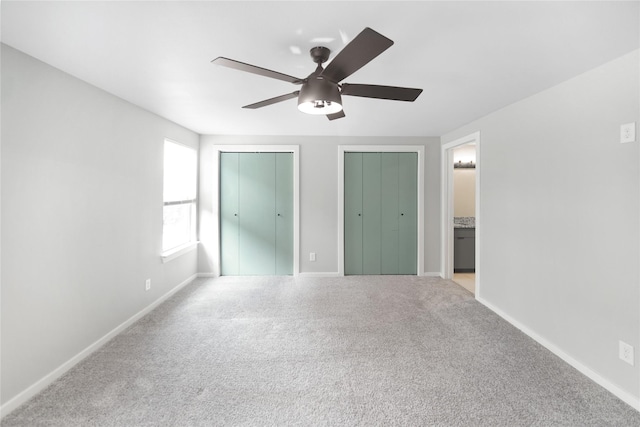 221 S 7th St, Jacksboro, TX 76458 - unfurnished bedroom with two closets, carpet flooring, and baseboards