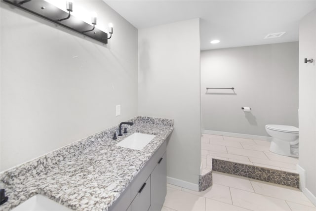 221 S 7th St, Jacksboro, TX 76458 - bathroom with vanity, toilet, baseboards, and recessed lighting