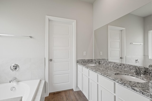 10605 Stag Ln, Fort Worth, TX 76036 - bathroom featuring a tub, double vanity, and wood finished floors