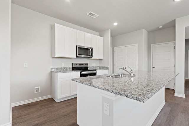 10605 Stag Ln, Fort Worth, TX 76036 - kitchen featuring appliances with stainless steel finishes, a sink, baseboards, dark wood-style floors, and white cabinets