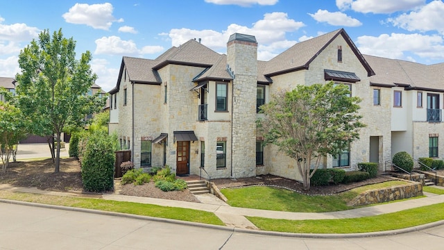 1120 Hemingway Ln, Irving, TX 75063 - view of front of house featuring stone siding, a chimney, and a shingled roof
