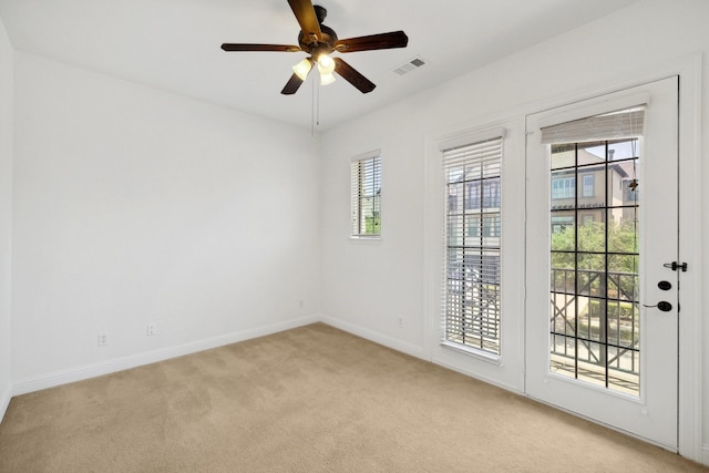 1120 Hemingway Ln, Irving, TX 75063 - empty room featuring light colored carpet, plenty of natural light, baseboards, and a ceiling fan