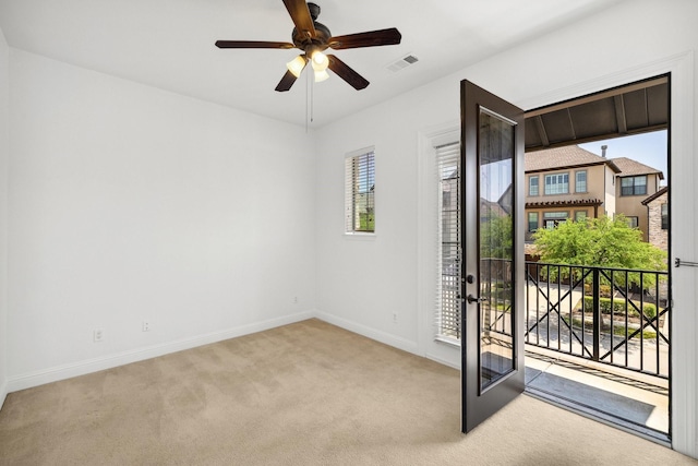1120 Hemingway Ln, Irving, TX 75063 - spare room featuring light colored carpet, baseboards, ceiling fan, and french doors