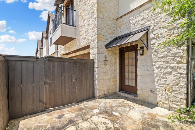 1120 Hemingway Ln, Irving, TX 75063 - property entrance with stone siding and a gate