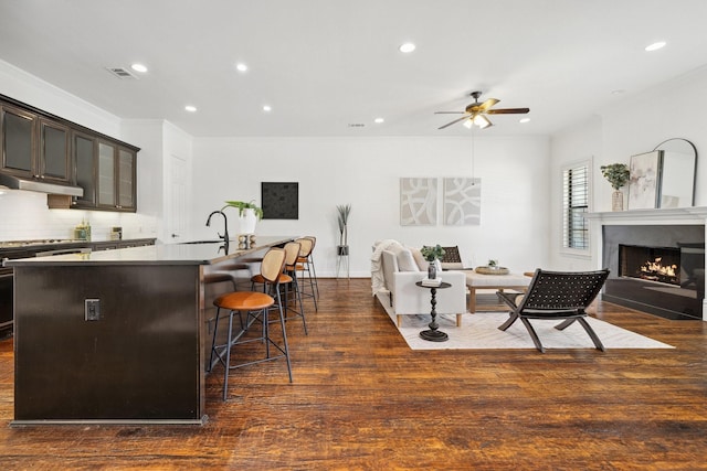 1120 Hemingway Ln, Irving, TX 75063 - kitchen with recessed lighting, a ceiling fan, open floor plan, dark wood-style floors, and a center island with sink