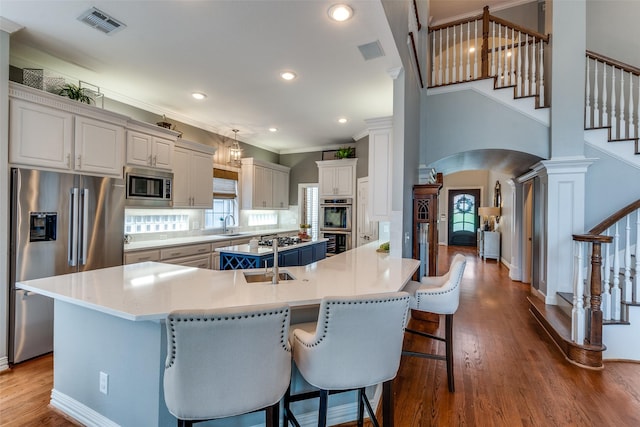 9352 Stratford Way, Dallas, TX 75220 - kitchen with stainless steel appliances, arched walkways, dark wood-style floors, a center island, and a breakfast bar