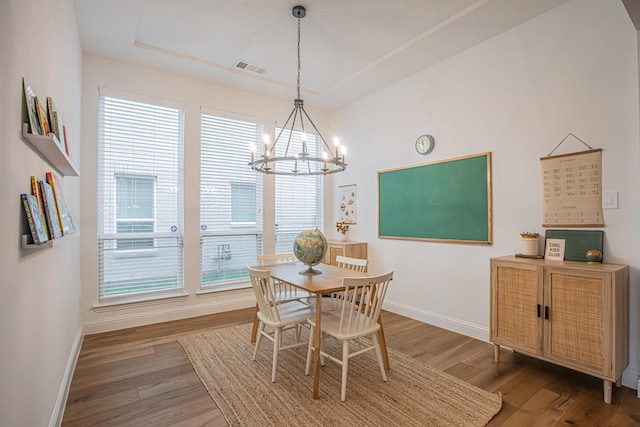 1050 Adair Rd, Prosper, TX 75078 - dining area with a chandelier, baseboards, wood finished floors, and a raised ceiling