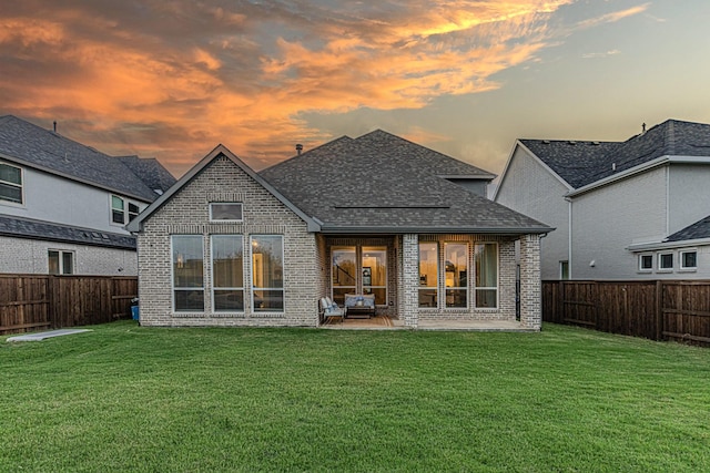 1050 Adair Rd, Prosper, TX 75078 - back of house at dusk with brick siding, a shingled roof, and a patio area