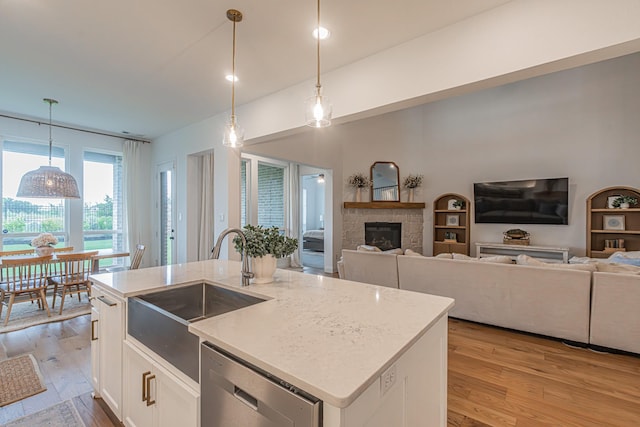 1050 Adair Rd, Prosper, TX 75078 - kitchen with dishwasher, a sink, light wood finished floors, a stone fireplace, and open floor plan