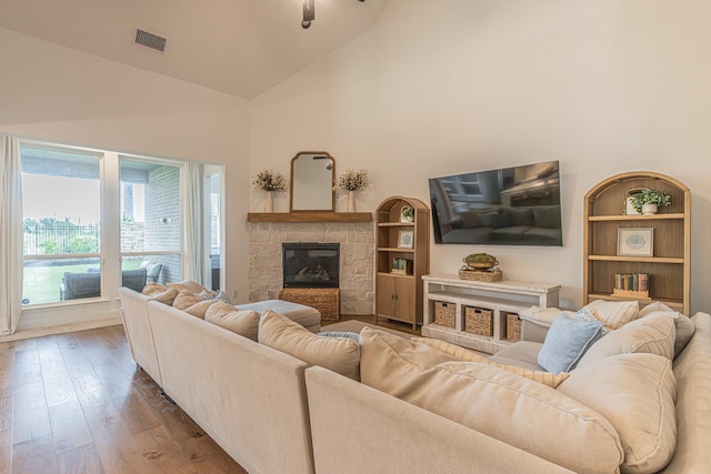 1050 Adair Rd, Prosper, TX 75078 - living room featuring high vaulted ceiling, wood finished floors, and a fireplace