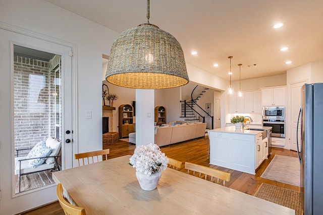 1050 Adair Rd, Prosper, TX 75078 - dining room with stairs, wood finished floors, and recessed lighting