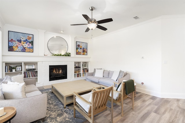 3509 Walington Dr, Plano, TX 75093 - living area featuring crown molding, a ceiling fan, wood finished floors, baseboards, and a fireplace