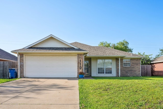 110 Apache Trl, Alvarado, TX 76009 - single story home featuring concrete driveway, brick siding, an attached garage, and roof with shingles