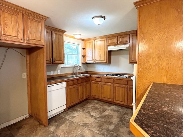 125 Park St E, Sulphur Springs, TX 75482 - kitchen featuring white appliances, a sink, under cabinet range hood, dark countertops, and brown cabinets