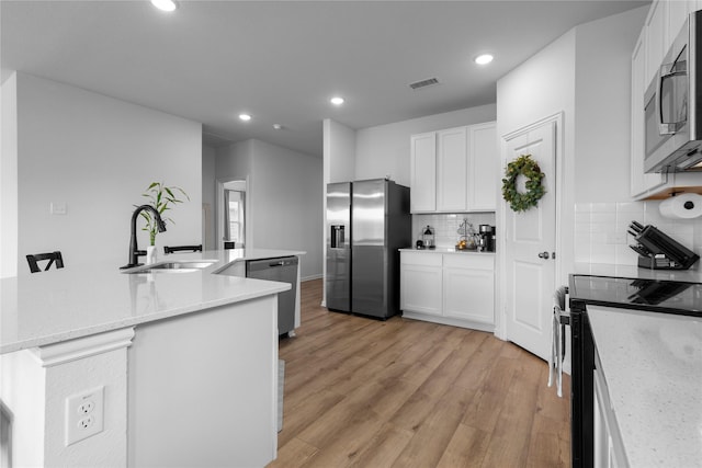 2939 Peony Dr, Sherman, TX 75092 - kitchen featuring a sink, stainless steel appliances, decorative backsplash, white cabinetry, and recessed lighting