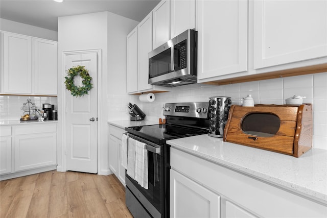 2939 Peony Dr, Sherman, TX 75092 - kitchen with appliances with stainless steel finishes, light wood-style floors, backsplash, white cabinets, and light stone countertops