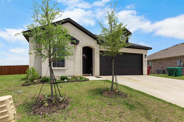 2939 Peony Dr, Sherman, TX 75092 - french country home featuring driveway, brick siding, a garage, and cooling unit