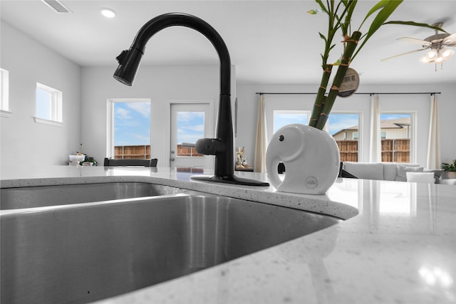 2939 Peony Dr, Sherman, TX 75092 - kitchen view of a sink, light stone counters, and recessed lighting