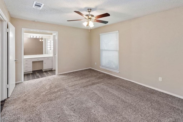 1425 Bryan Dr, Bedford, TX 76022 - unfurnished bedroom with carpet flooring, a textured ceiling, baseboards, an office area, and connected bathroom