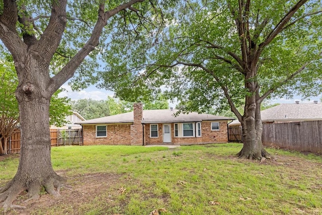 1425 Bryan Dr, Bedford, TX 76022 - back of property with brick siding and a chimney