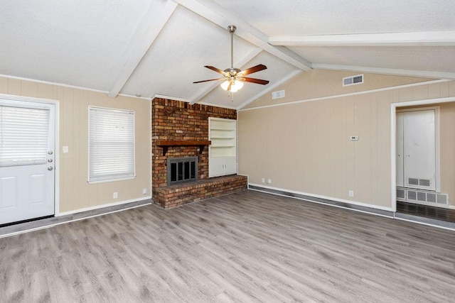 1425 Bryan Dr, Bedford, TX 76022 - unfurnished living room featuring wood finished floors, a ceiling fan, a brick fireplace, and baseboards