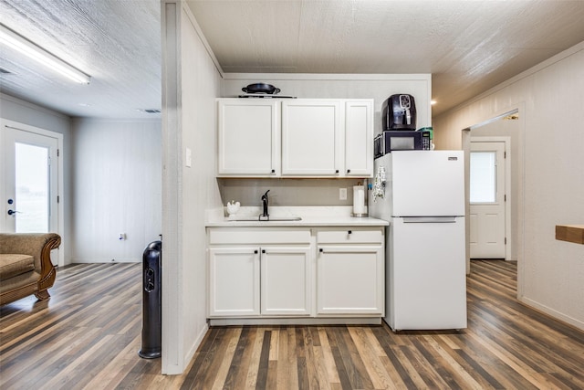 5205 Larue Dr, Caddo Mills, TX 75135 - kitchen with freestanding refrigerator, a sink, crown molding, white cabinetry, and wood finished floors