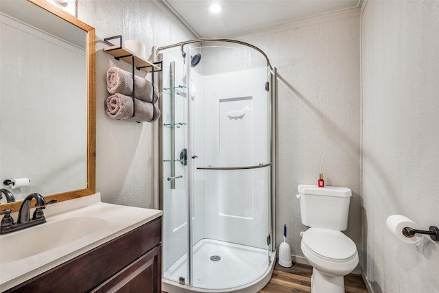 5205 Larue Dr, Caddo Mills, TX 75135 - full bathroom featuring a stall shower, wood finished floors, vanity, toilet, and a textured wall