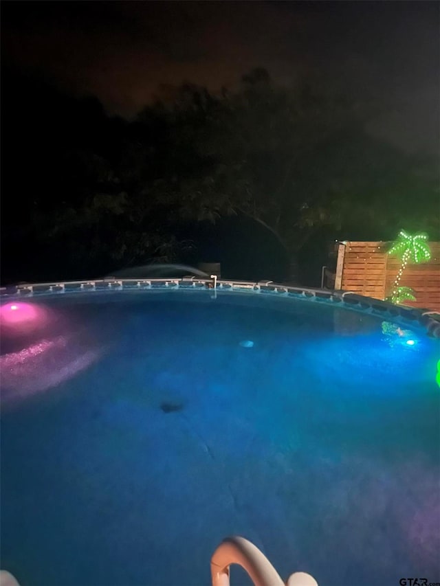 2620 N State Highway 37, Quitman, TX 75783 - pool at night featuring an outdoor pool and oil tank