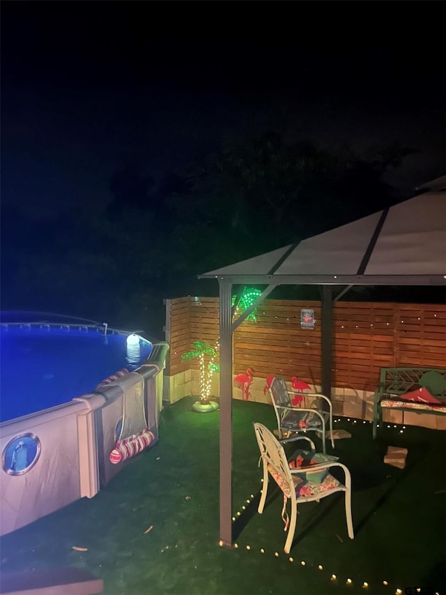 2620 N State Highway 37, Quitman, TX 75783 - patio at twilight with a gazebo and an outdoor pool