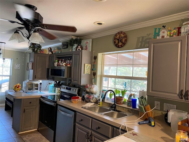 2620 N State Highway 37, Quitman, TX 75783 - kitchen with appliances with stainless steel finishes, ornamental molding, ceiling fan, a peninsula, and light countertops