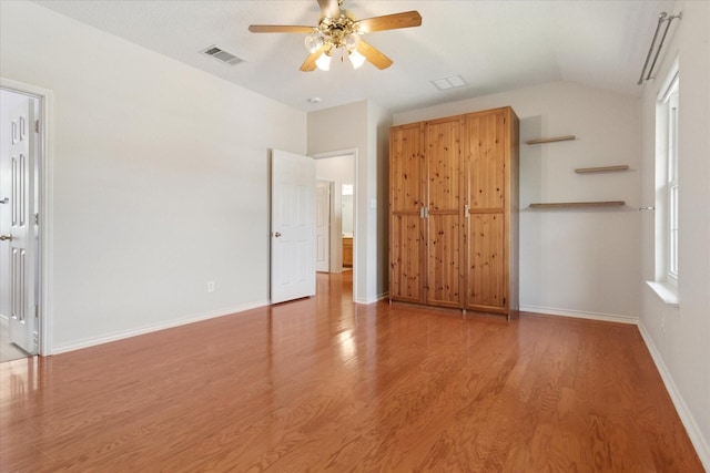 1302 Woodmont Dr, Allen, TX 75002 - unfurnished bedroom featuring light wood-style flooring, vaulted ceiling, ceiling fan, and baseboards