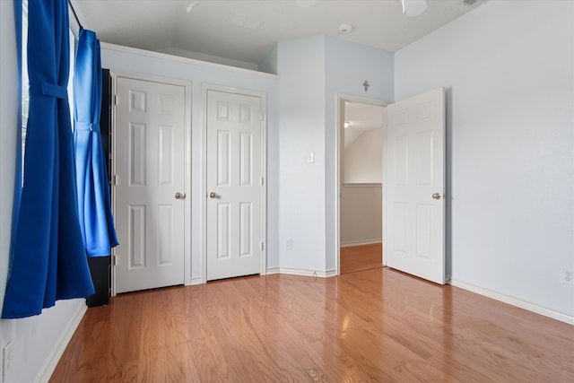 1302 Woodmont Dr, Allen, TX 75002 - unfurnished bedroom with wood finished floors, baseboards, and ceiling fan