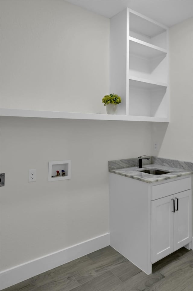 5506 Cold Water Trl, Granbury, TX 76048 - laundry room featuring electric dryer hookup, hookup for a washing machine, a sink, and baseboards